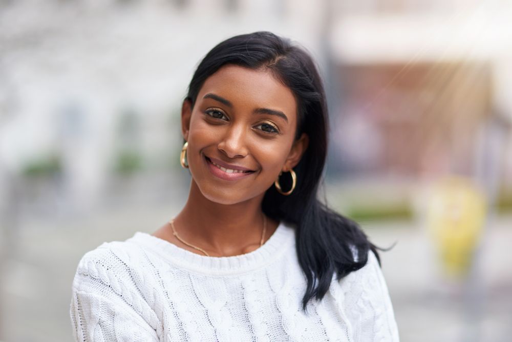 Smiling woman with bright, healthy teeth, representing confidence after cosmetic or restorative dental care
