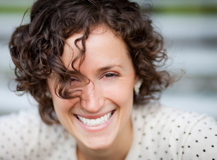 Close-up of smiling woman with bright, healthy teeth, representing confident cosmetic dental results
