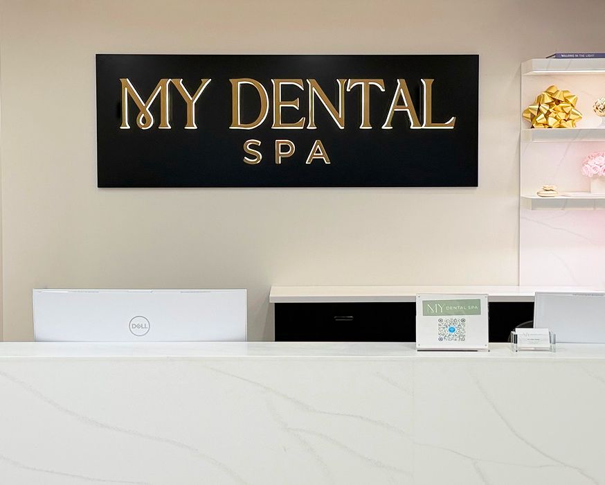 My Dental Spa logo behind our front office desk