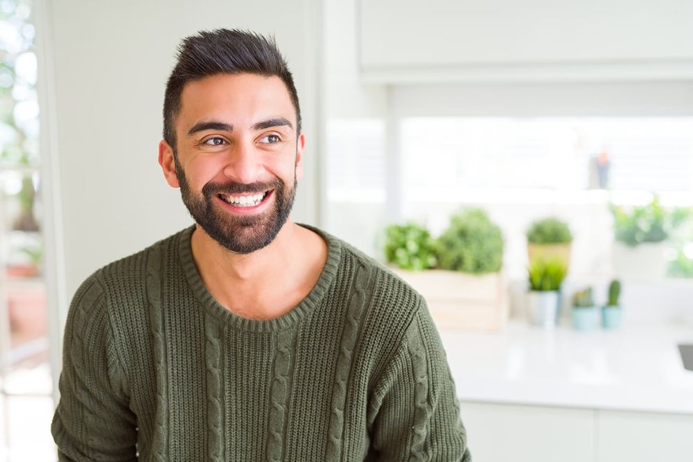 Smiling man with bright, healthy teeth, representing confidence after cosmetic or restorative dental care