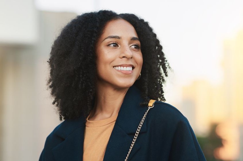 Smiling woman with bright, healthy teeth, representing confidence after cosmetic dental care