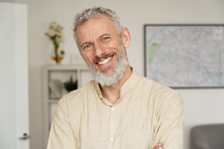 Smiling middle-aged man with healthy teeth, representing confident results from cosmetic dental care